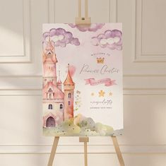 an easel with a card on it displaying a princess's castle and clouds