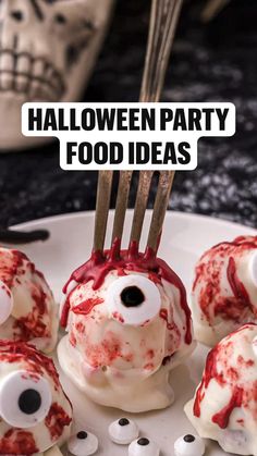 a white plate topped with lots of food covered in red and black spooky eyes