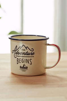 a coffee mug sitting on top of a wooden table