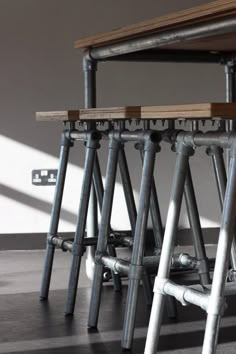 three metal stools sitting next to each other