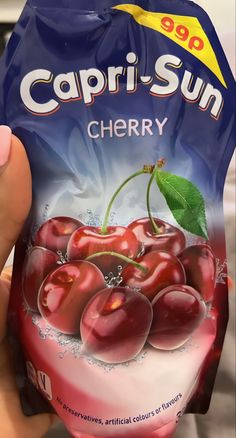 a bag of capri - sun cherries is being held up