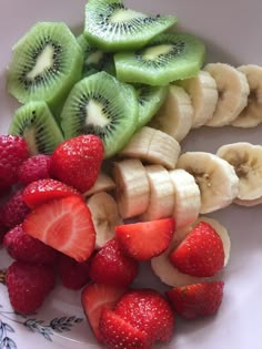 sliced bananas, strawberries and kiwi on a plate