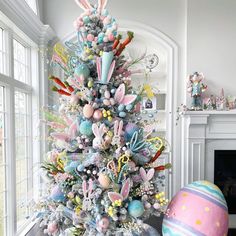 a decorated christmas tree in the corner of a living room with an egg on the floor