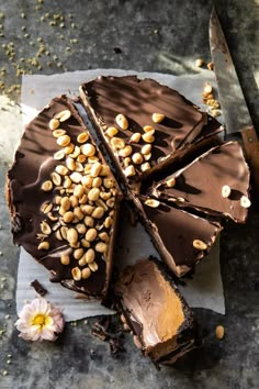 there is a chocolate cake with nuts on it