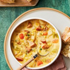 a bowl of soup with bread on the side