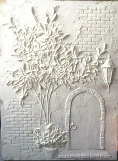 a white brick wall with a tree on it