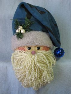 a close up of a santa clause hat on a white surface with ornaments around it