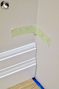 the corner of a room with some tape on it