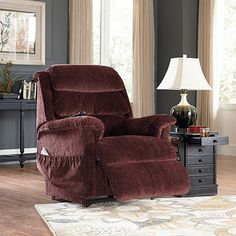 a living room with a recliner chair and lamp on the table in front of it