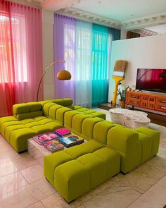 a living room filled with furniture and colorful curtains