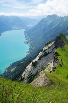 a view from the top of a mountain looking down at a lake