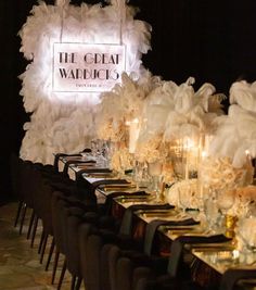 a long table is set up for a formal event with candles and centerpieces