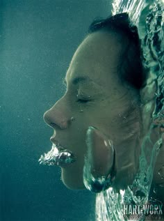 a woman in the water with her eyes closed