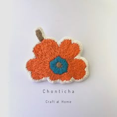 an orange and blue flower with the words chonttcha craft at home on it