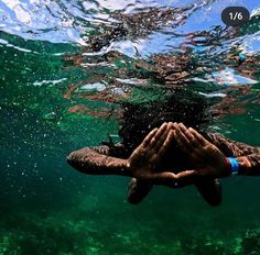 a person holding their hands under the water