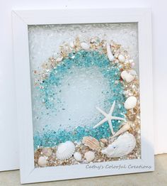 a white frame with sea shells and starfish on it