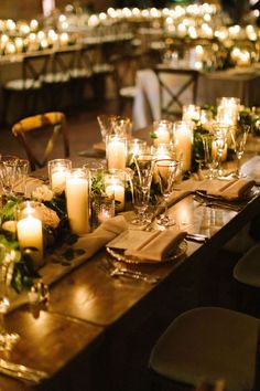 a long table is set with candles and flowers for an elegant dinner or party event