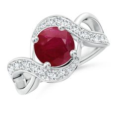 a ring with a red stone and diamonds on the band, set in white gold