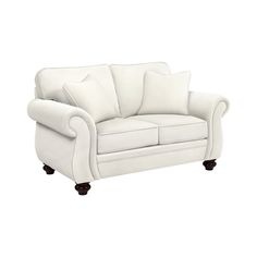 a white couch with pillows on it