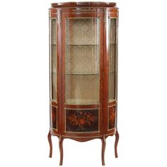 an ornate display cabinet with glass doors