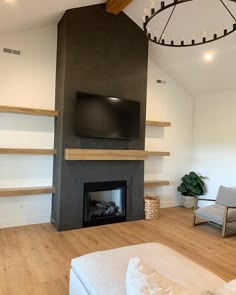 a living room with a fire place and a television on top of the fireplace mantel