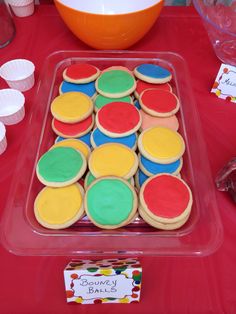 there is a tray of cookies on the table with cupcakes next to it