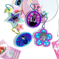 various personalized items are displayed on a white surface with pink and blue accents, such as star shaped magnets