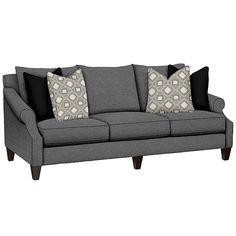 a gray couch with black and white pillows