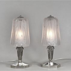 two lamps sitting next to each other on a table