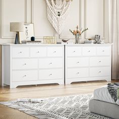 a living room with a white dresser and rug on top of the wooden flooring