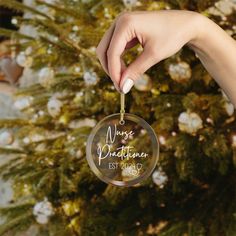 a woman's hand holding a glass ornament with the words, marriage and best wishes on it