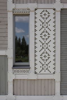 a window on the side of a house that is being constructed with wood and white paint