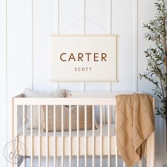 a white crib with a sign that says carter scott