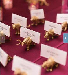 small gold elephants are placed on place cards