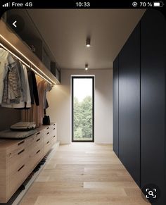 an open closet with clothes hanging on the wall and doors to another room in front of it