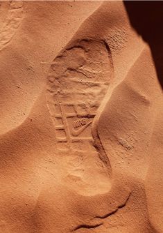 a person's shoe imprint in the sand