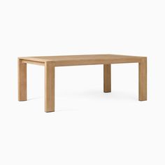 a wooden table sitting on top of a white floor