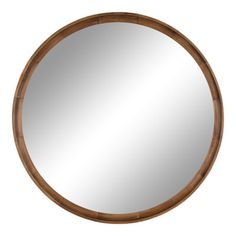 a round wooden mirror hanging on the wall