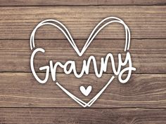 the word granny written in a heart shaped cutout on wooden background with copy space