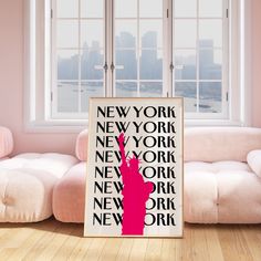 a new york poster with the statue of liberty on it in front of a window