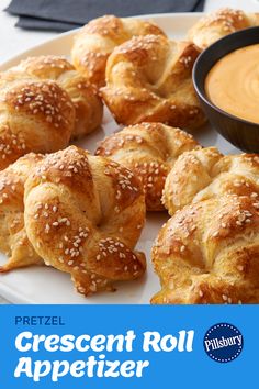 pretzel crescent roll appetizers on a plate with dipping sauce