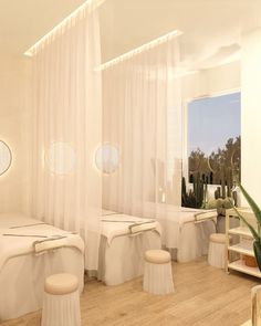 the interior of a spa with white linens and round mirrors on the windowsill