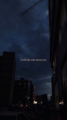 the words i roll the stars about you are lit up in the dark sky above some buildings