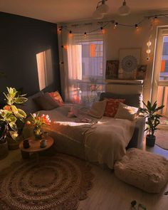 a living room filled with furniture and lots of lights hanging from the ceiling above it