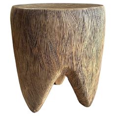 a wooden stool with an unusual design on the top and bottom, sitting in front of a white background