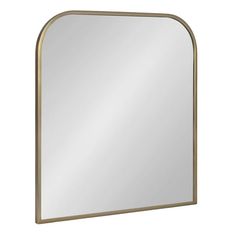 a gold framed mirror with an arched design on the front and bottom edge, against a white background