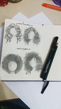 an open notebook with drawings of women's hair on it and a pen next to it