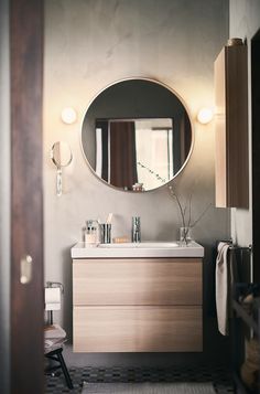 a bathroom with a sink, mirror and stool