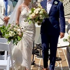 a bride and groom walking down the aisle