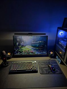 a computer desk with a keyboard, mouse and monitor lit up by blue light from behind